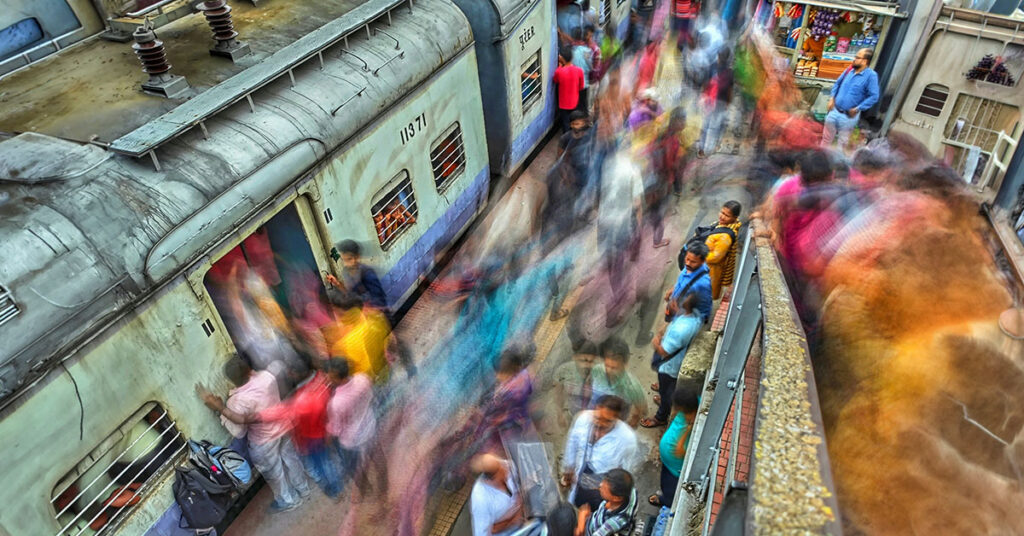 Crowded Indian train platform representing an overwhelming journey